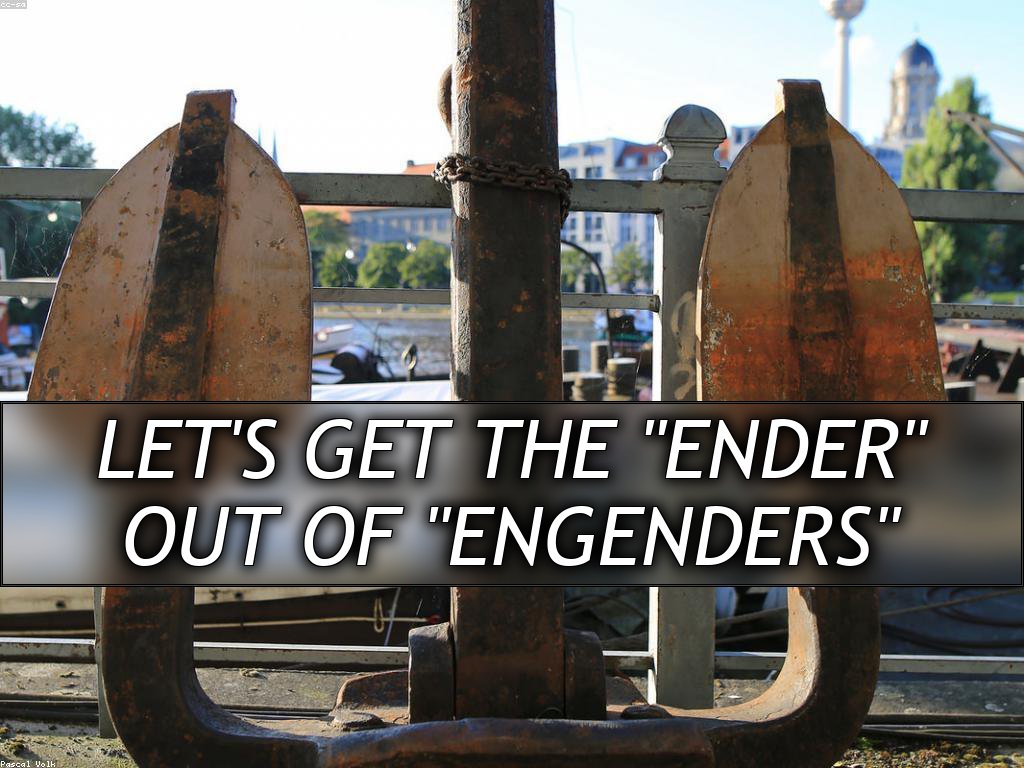 A large rusty anchor, leaning up against a bridge