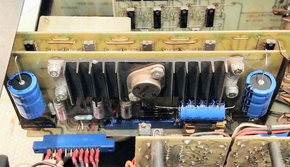 The power supply board for the digital section. We replaced the three blue filter capacitors that went bad. The board has a large transistor on a heat sink.