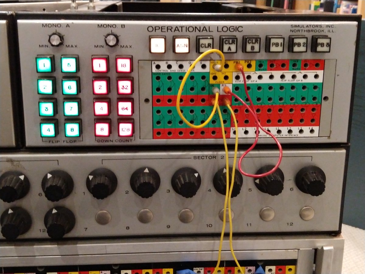 The digital section is programmed by a patch panel. 16 lights to the left show the status of the flip flops and counter.