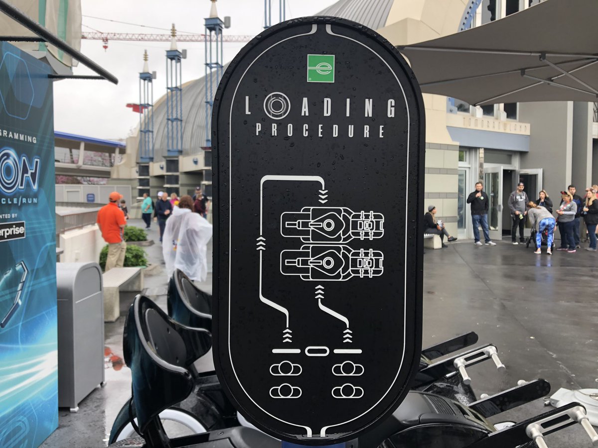 WDWNT's tweet photo. Arrows have been added around the TRON Lightcycle Run test bikes at the Magic Kingdom. The loading process is a bit unique, with one person walking behind the bikes to board on the opposite side. https://t.co/nYbXo94JvA