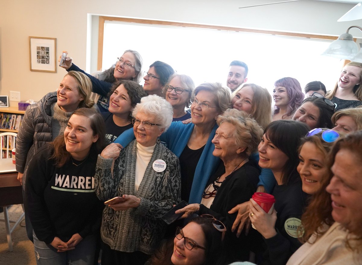 Elizabeth Warren takes a photo with a group of volunteers.
