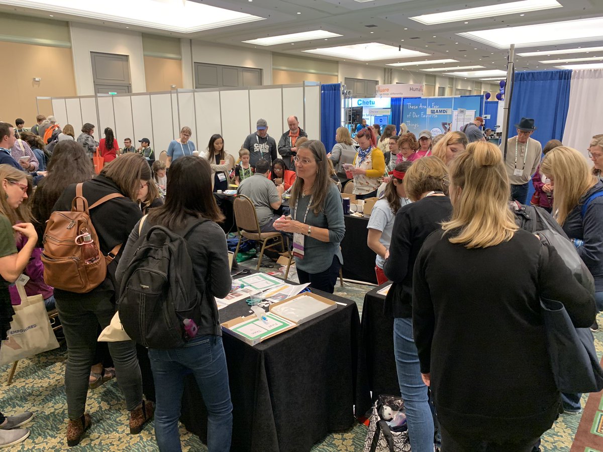 Judie at AT Maker event at ATIA surrounded by people.