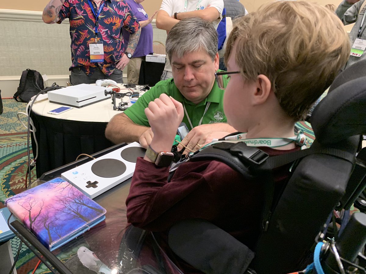 Bill Binko adjusting a joystick for a person using an adapted controller.