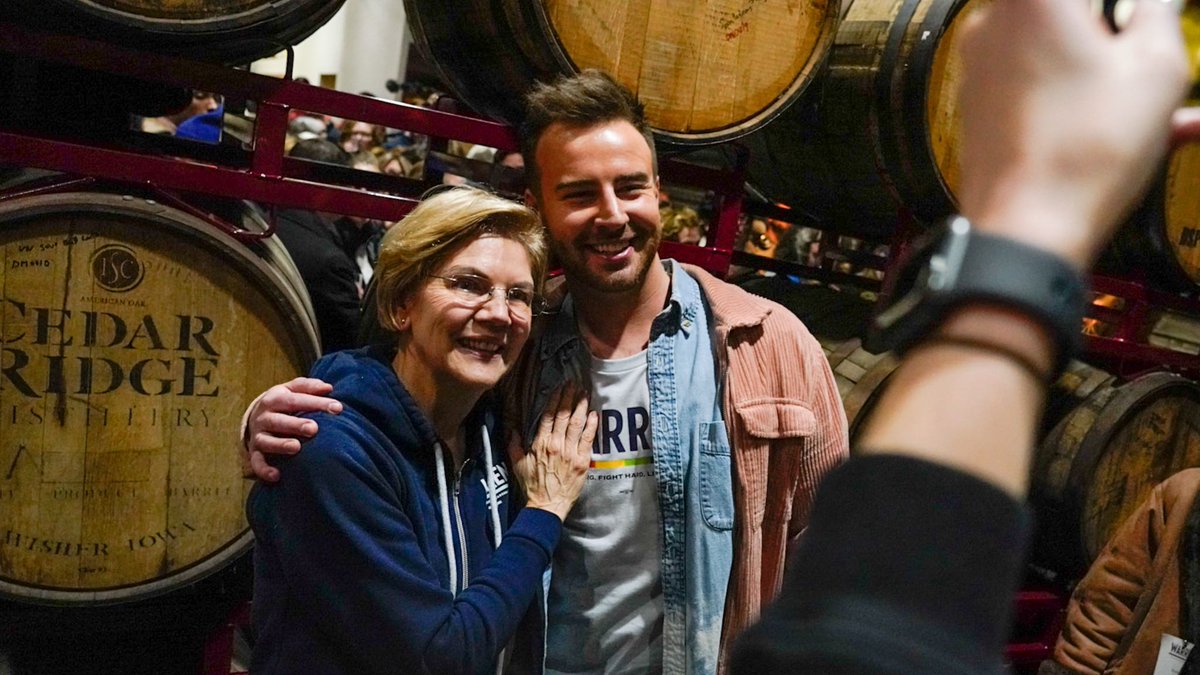 Elizabeth Warren takes a photo with a supporter.