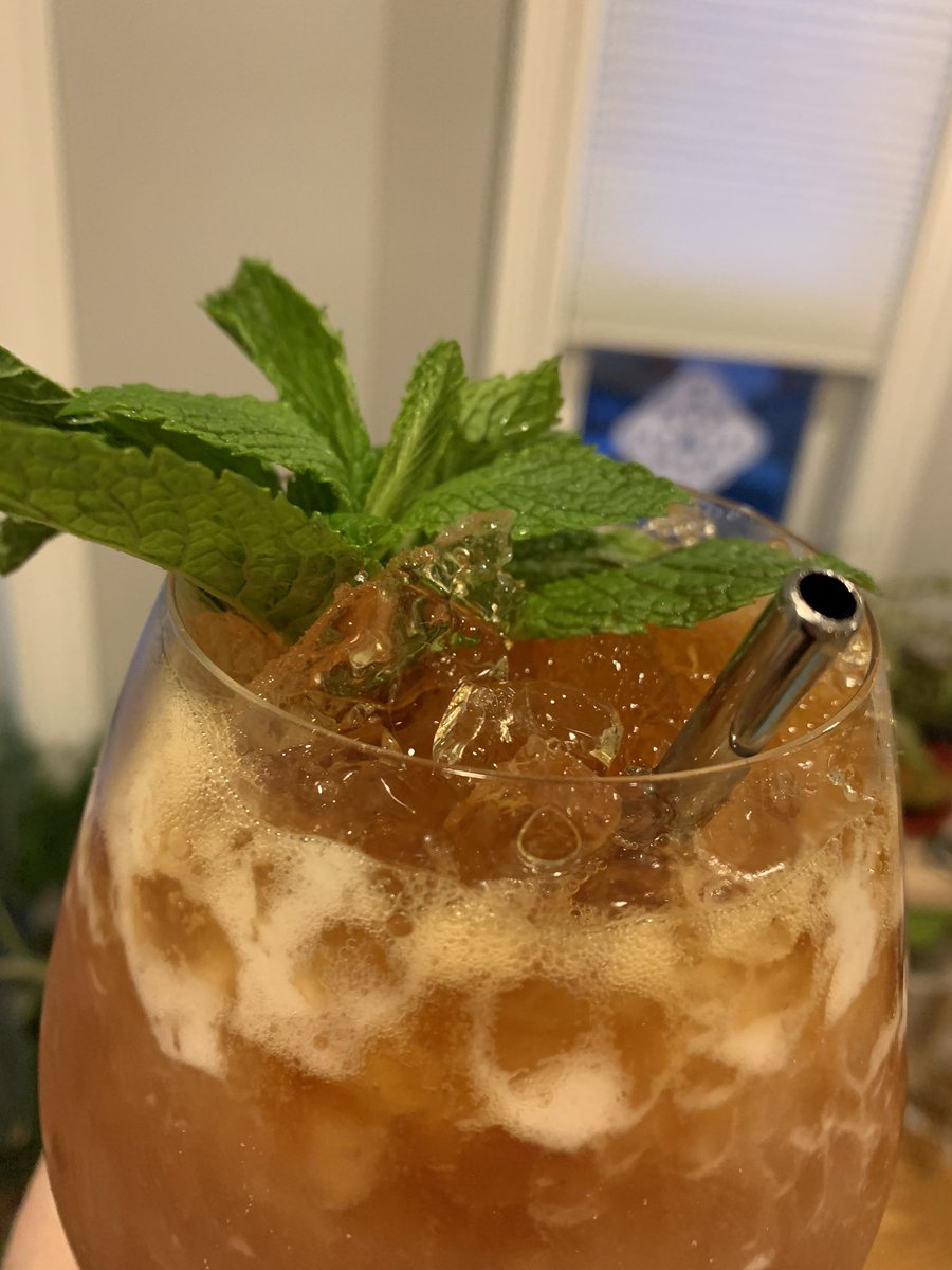 a big tiki drink topped with mint