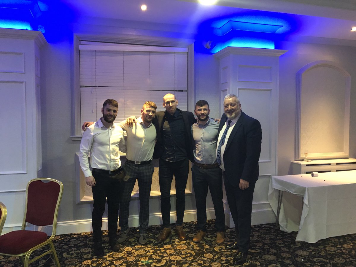 PatCatney's tweet photo. The McMullan brothers and Sean O Sullivan. A lot of Gold on display. 4 time all Ireland winner. ⁦@SeanTheBawn⁩ ⁦@AontroimGAA⁩ ⁦@benmcmullan9⁩ #GreatNight https://t.co/USKEbPkHiA