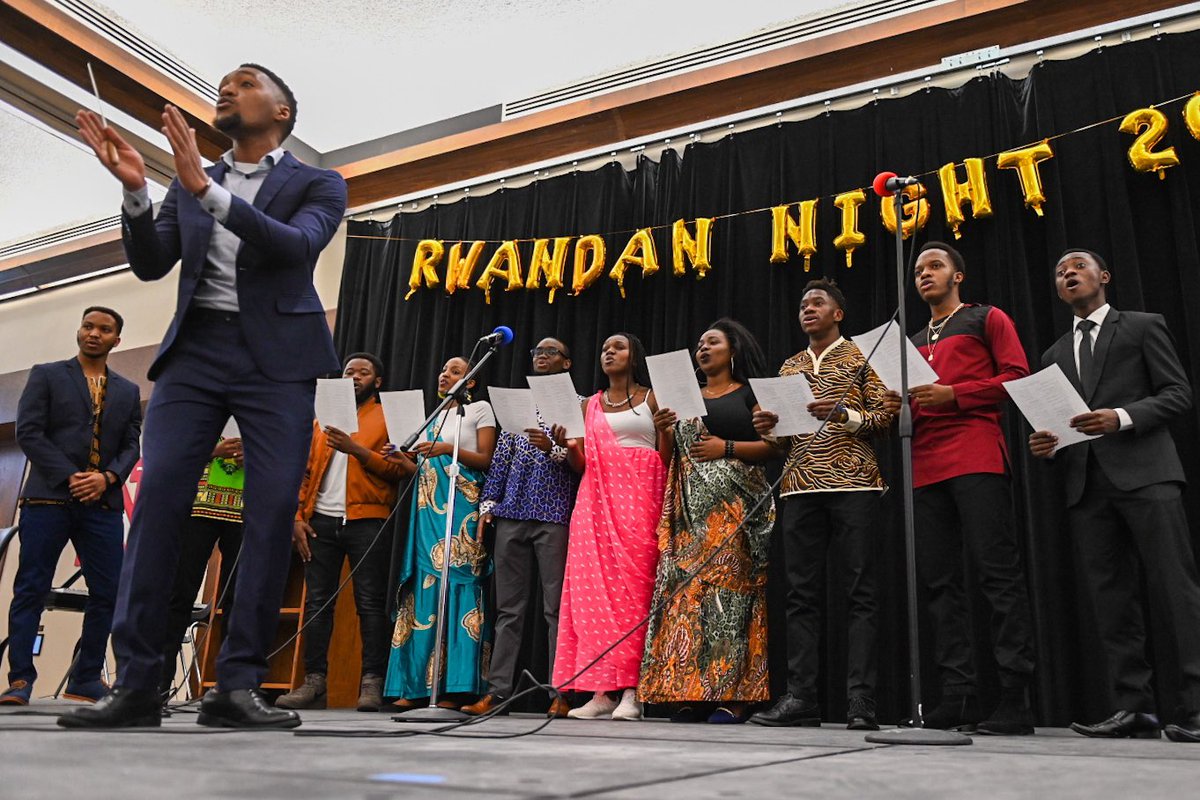 Rwanda scholars singing on stage.