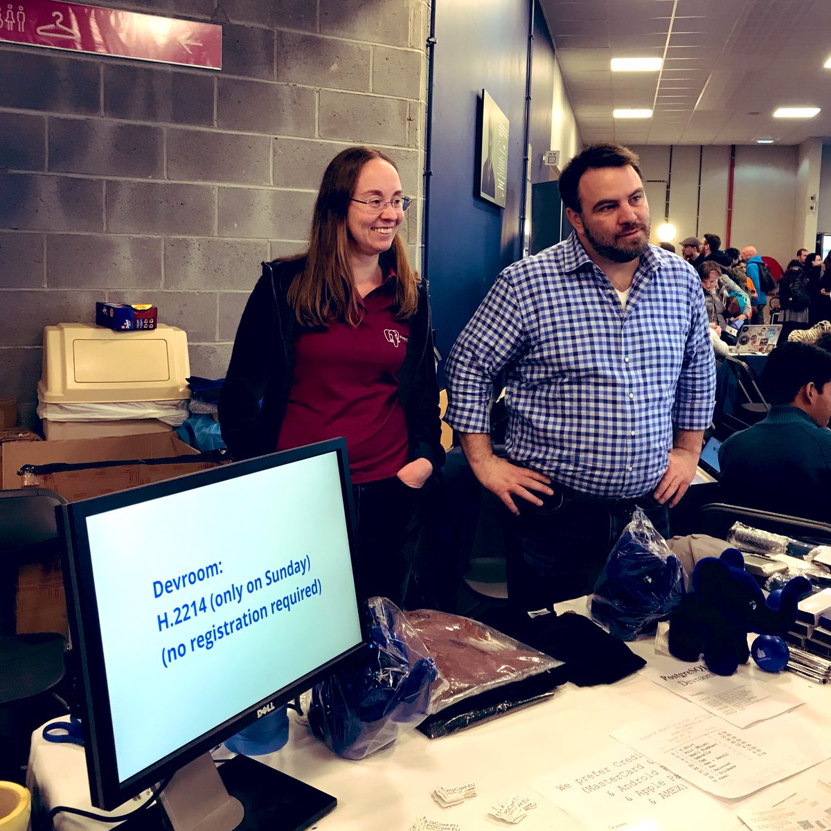 Postgres booth at FOSDEM'20, staffed by Olga Kalinina and Stephen Frost