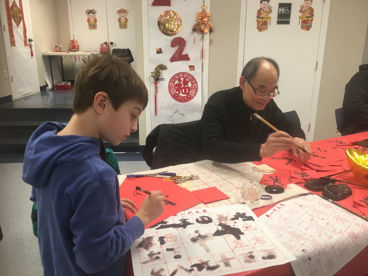Student drawing calligraphy characters in Mandarin