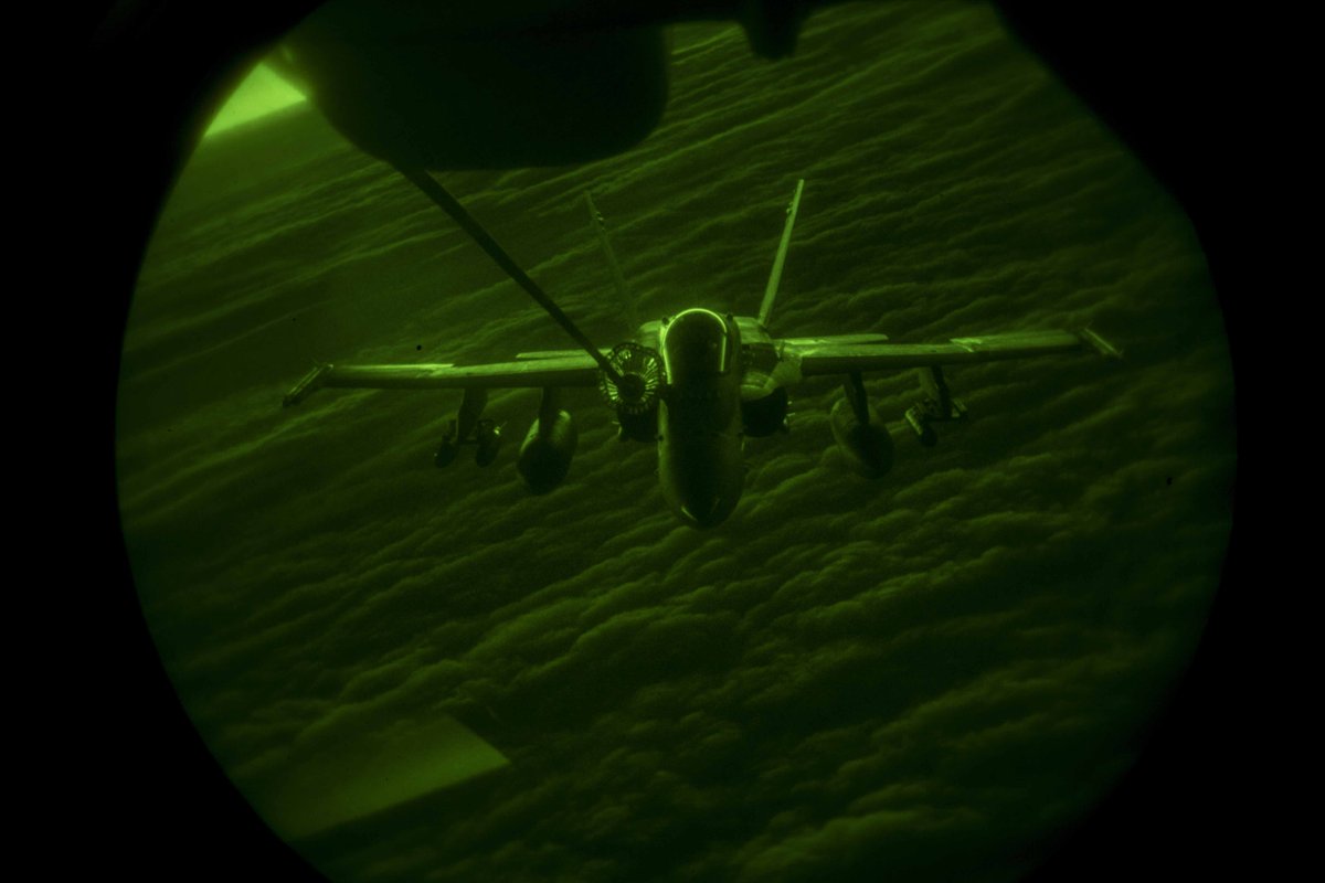 A Marine Corps fighter jet is refueled mid-air over Iraq.
