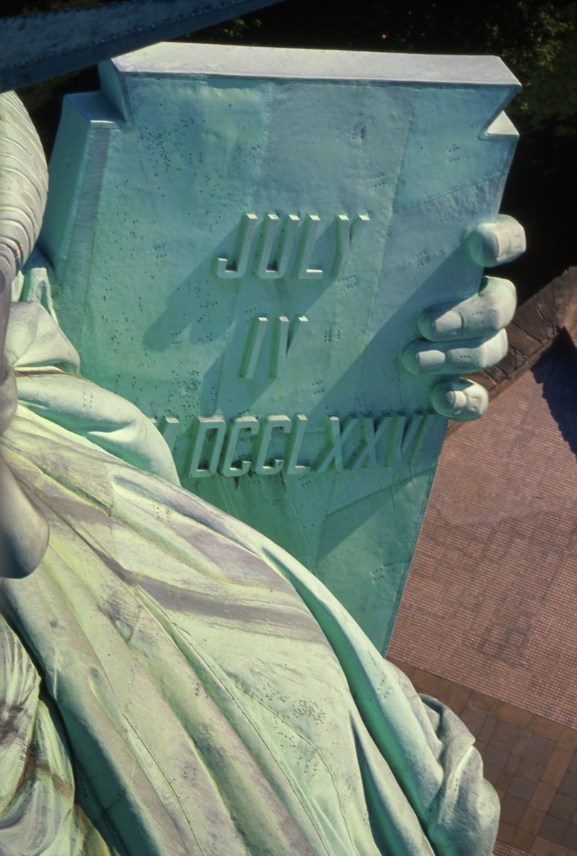 Photo of Lady Liberty's tablet taken from the torch featuring July 4th, 1776 written in roman numerals.