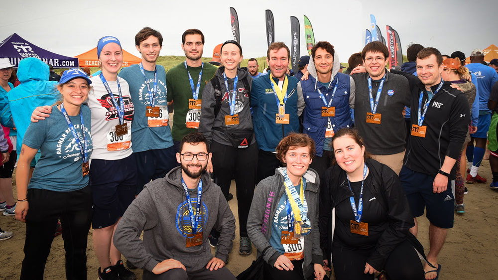Outdoor group picture. Everyone has a smile on their face and a relay medal around their neck.