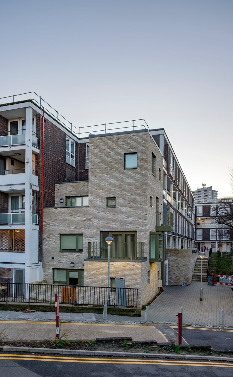 21) This is a part infill, part regeneration project within an existing estate, with a row of new houses on what used to be a disused steep slope, and a few new additions built into the existing estate buildings.