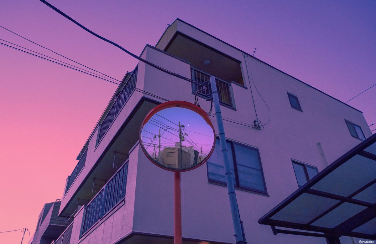 A picture of a mirror, taken during a sunset in Tokyo