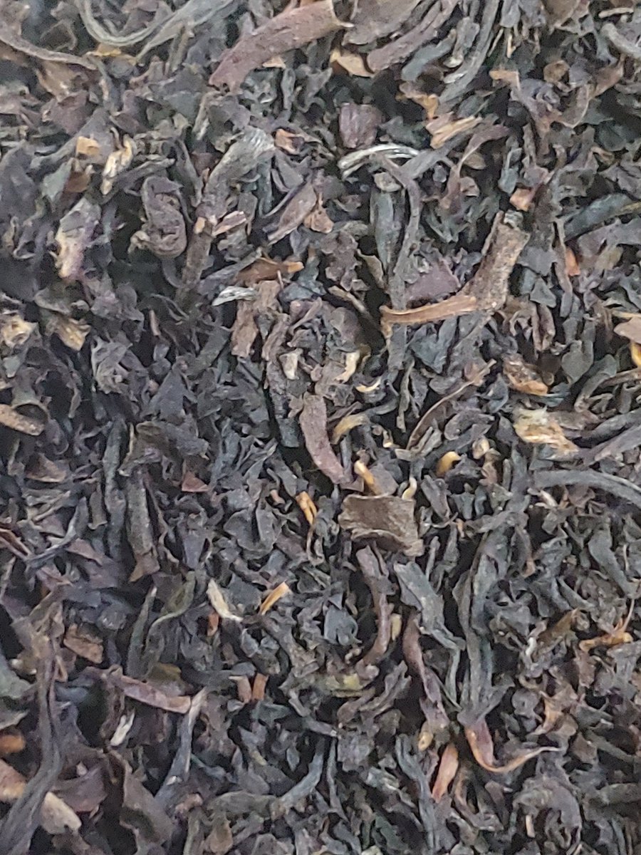 A closeup image of a blend of black tea leaves.