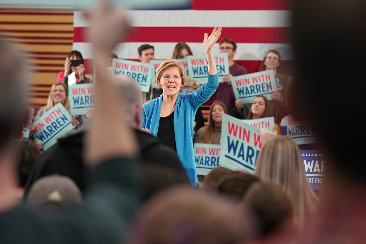 Elizabeth Warren waves to crowds of supporters.