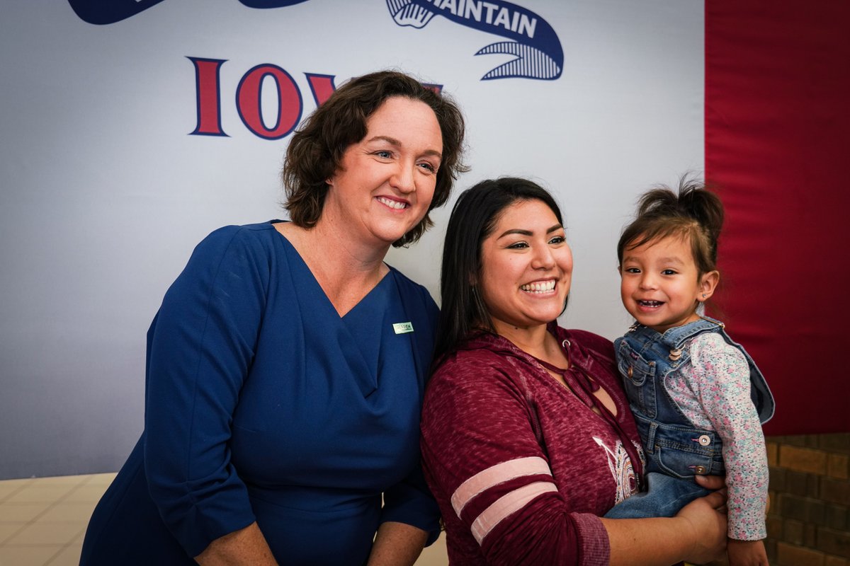 Rep. Katie Porter takes a picture with an Elizabeth Warren supporter and her baby.