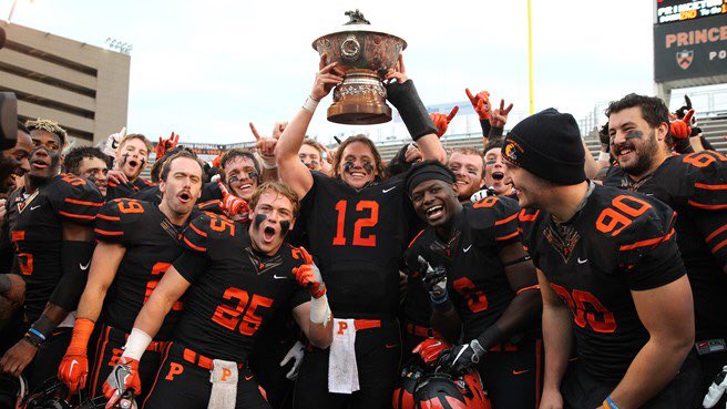 Princeton Football players raise up the Ivy League trophy in celebration