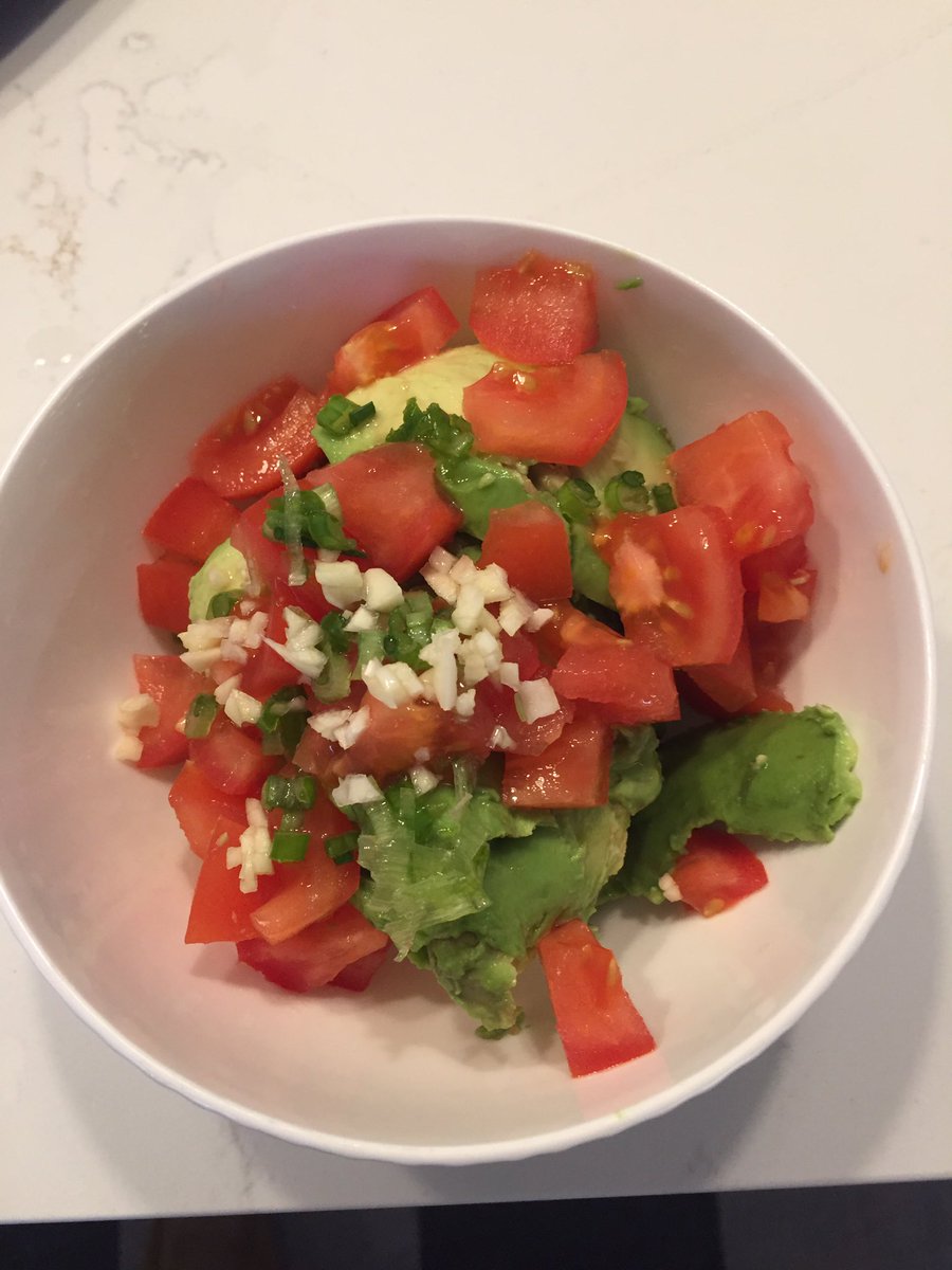 Two avocados, half tomato, green onion, fresh garlic, lemon juice, pinch of salt... then mash