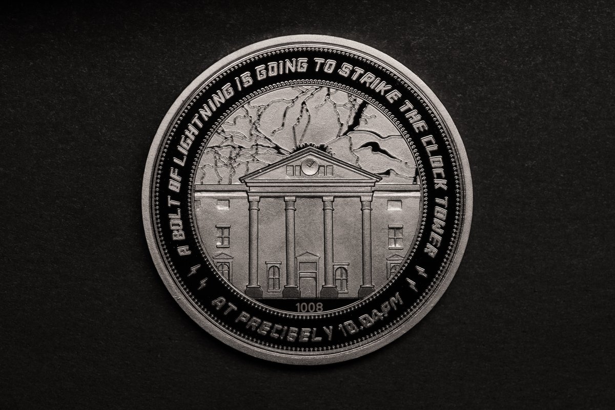 Front side reads "A Bolt of Lightning is Going to Strike the Clock Tower at Precisely 10:04 PM" and features the individual coin number.