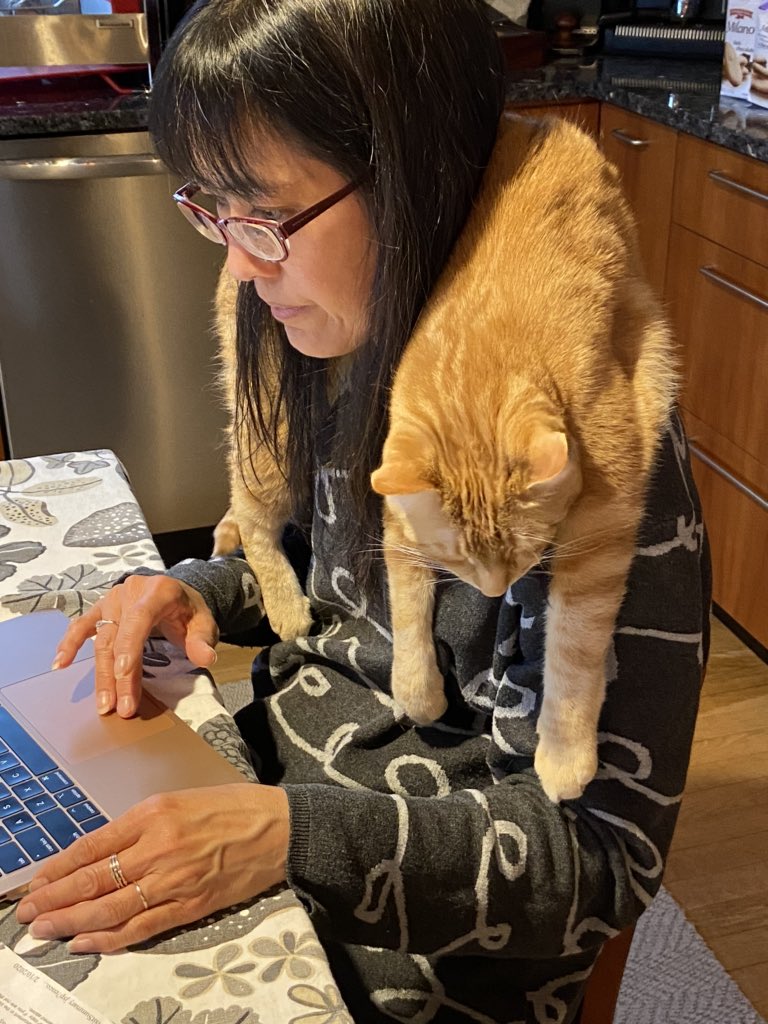 My mom and her cat Hobbes! He just likes sleepin like that