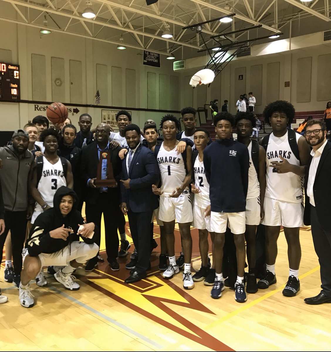 sharksboysbball's tweet photo. On Day 1 @USchoolMBB_HC wrote on the board “FAMILY” = Forget About Me, I Love You. This right here is what it’s all about! District Champs! We’re back in Regional action Thursday night - Stay tuned for the schedule. https://t.co/H2MPbBld0H