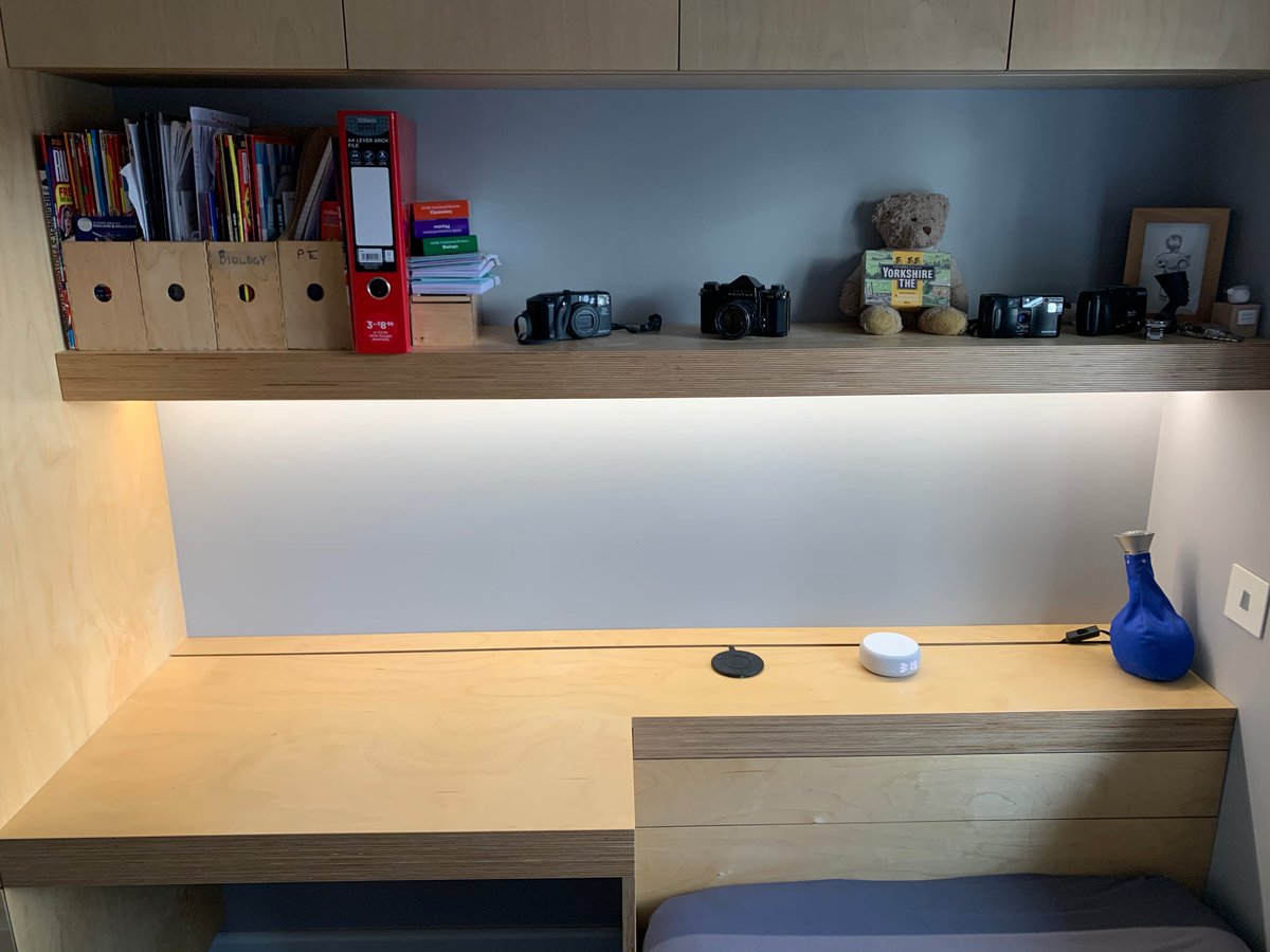 Recessed dimmable LED’s along with a very simple but effective cable access panel with brush strip along the back edge.  There’s also a colour changing strip along the front edge #bespokestudy #bespokefittedfurniture #birchplyfurniture