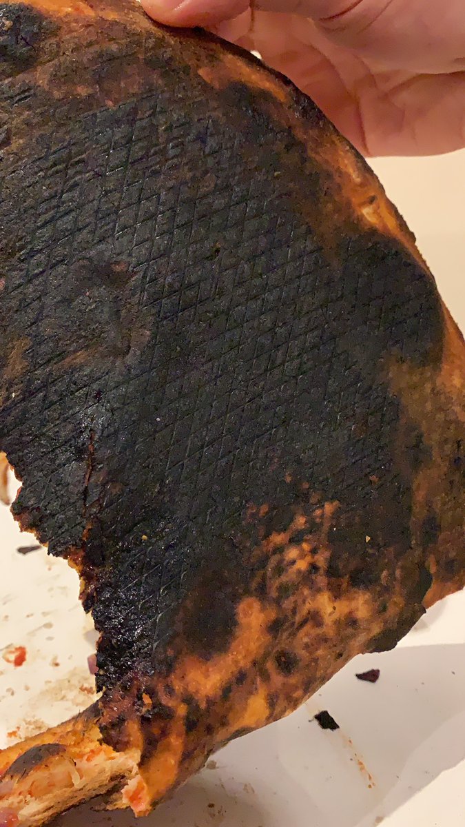 Gee_Robertson's tweet photo. @PizzaExpress how on earth is it acceptable that you have just delivered me a pizza THIS burnt from your Battersea bridge branch. https://t.co/O07Gyr5Ll1
