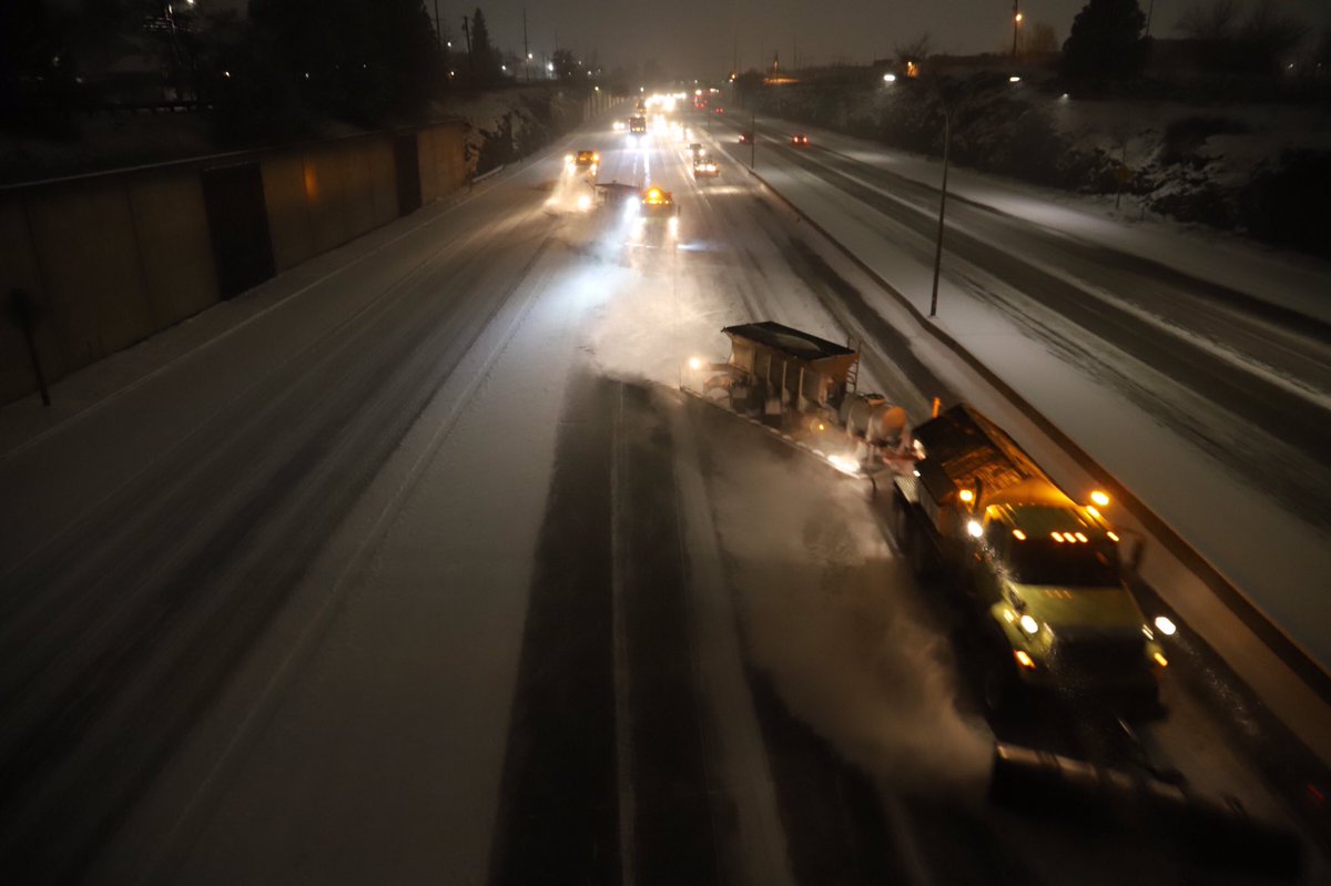 Three plows, plowing I-90 through Spokane.