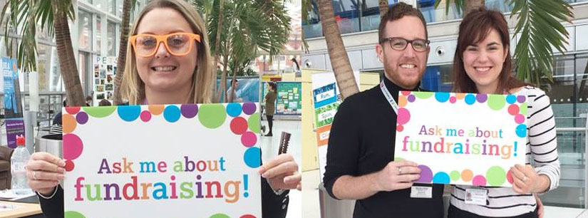 Evelina London staff holding posters that say "Ask me about fundraising" 