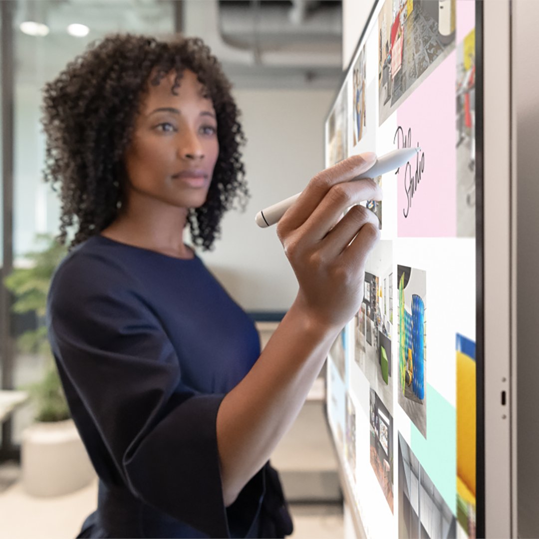 A wall-mounted Surface Hub 2S in a beautiful modern office environment. 