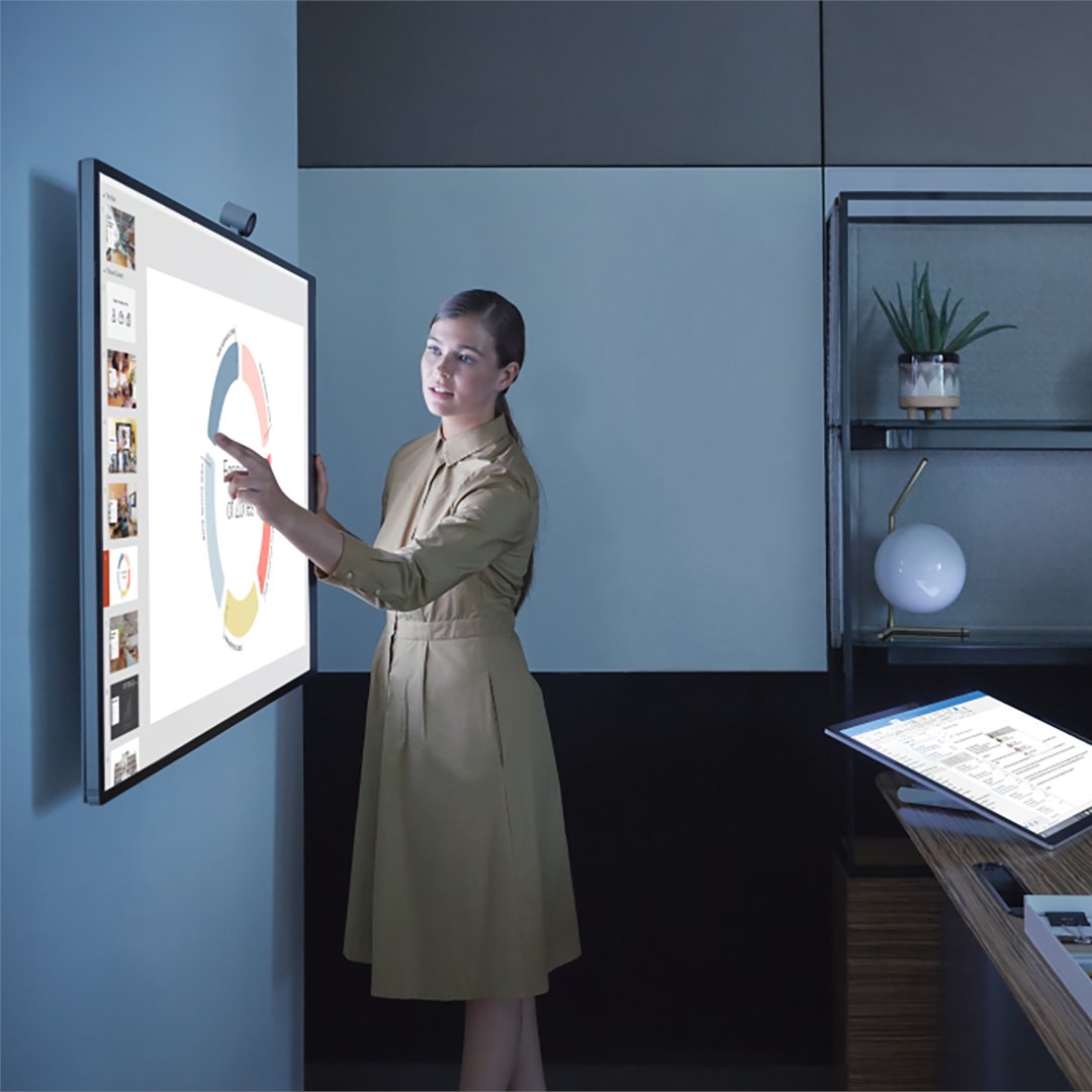 A wall-mounted Surface Hub 2S in a beautiful modern office environment. 
