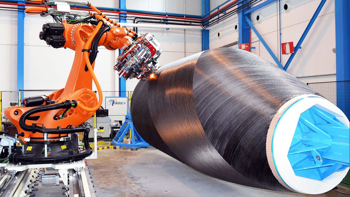 A machine is refining and cutting a large peice of metal.