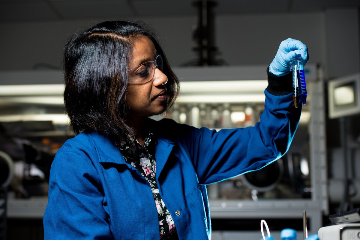 scientist holding test tubes