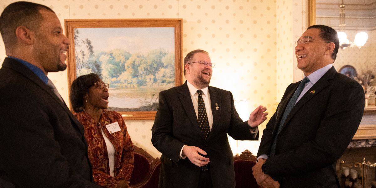 Chancellor Cartwright laughs with Prime Minister Holness and others