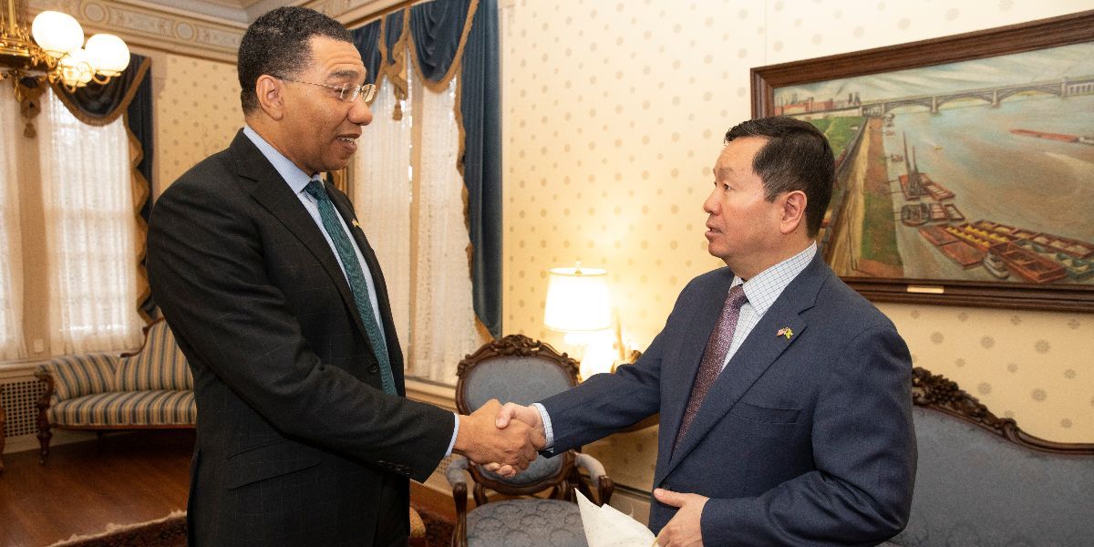 Prime Minister Holness shakes hands with UM System President Mun Choi