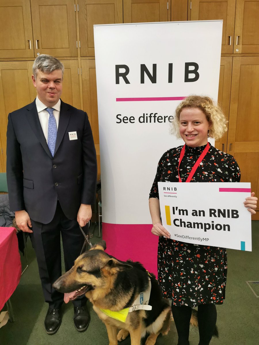 I am standing in Parliament with David from RNIB and Dennis the guide dog.