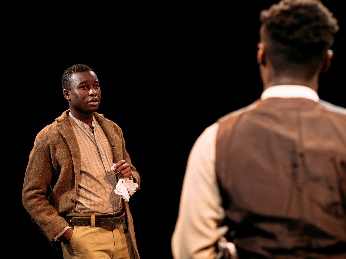 Two actors on stage having a conversation