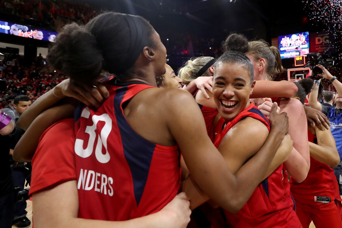 a photo of the Washington Mystics basketball team celebrating their W N B A championship