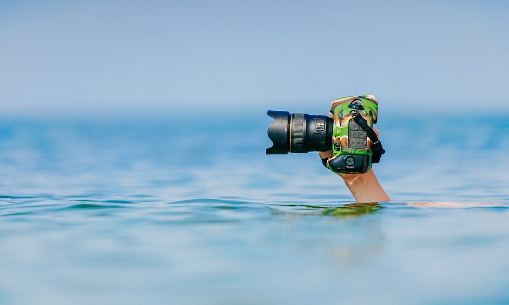 Camera being held above water