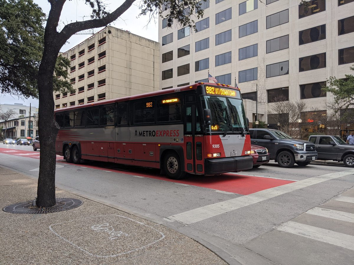 Photo of bus in red transit priority lane.