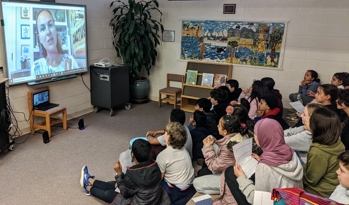 MES__Library's tweet photo. Ms. Pugh's 5th graders Skyped with @Dusti_Bowling today for #WorldReadAloudDay! They asked excellent questions and found out what inspired her to create characters with limb differences and why positive representation of people with tic disorders is important. #POGcommunicator https://t.co/M5CQfDJ3qh