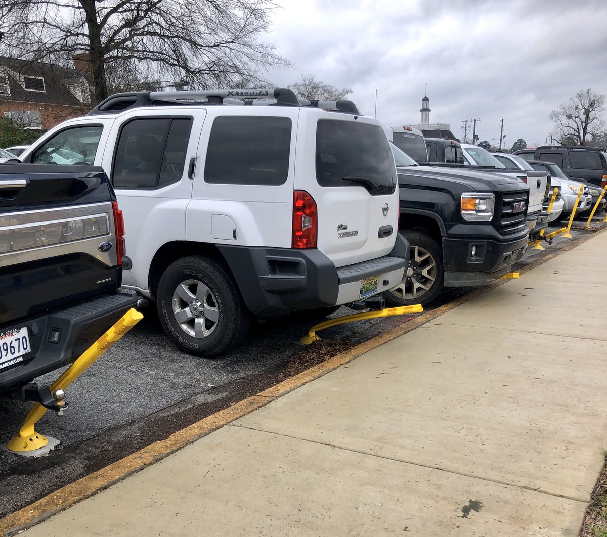 Oversized vehicles parked on flexible bollards.