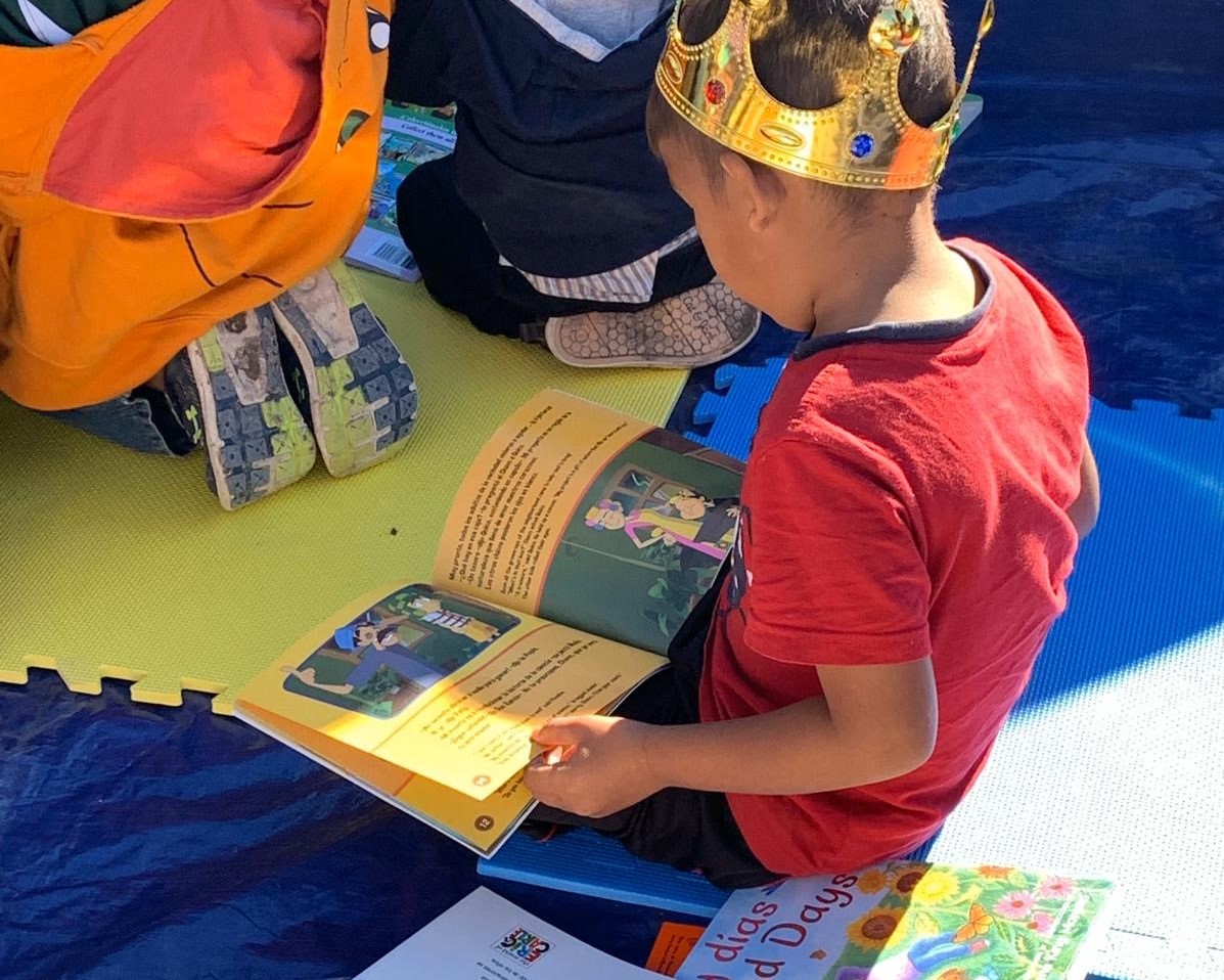 A child reads one of the many bilingual books brought to asylum seekers by volunteers.