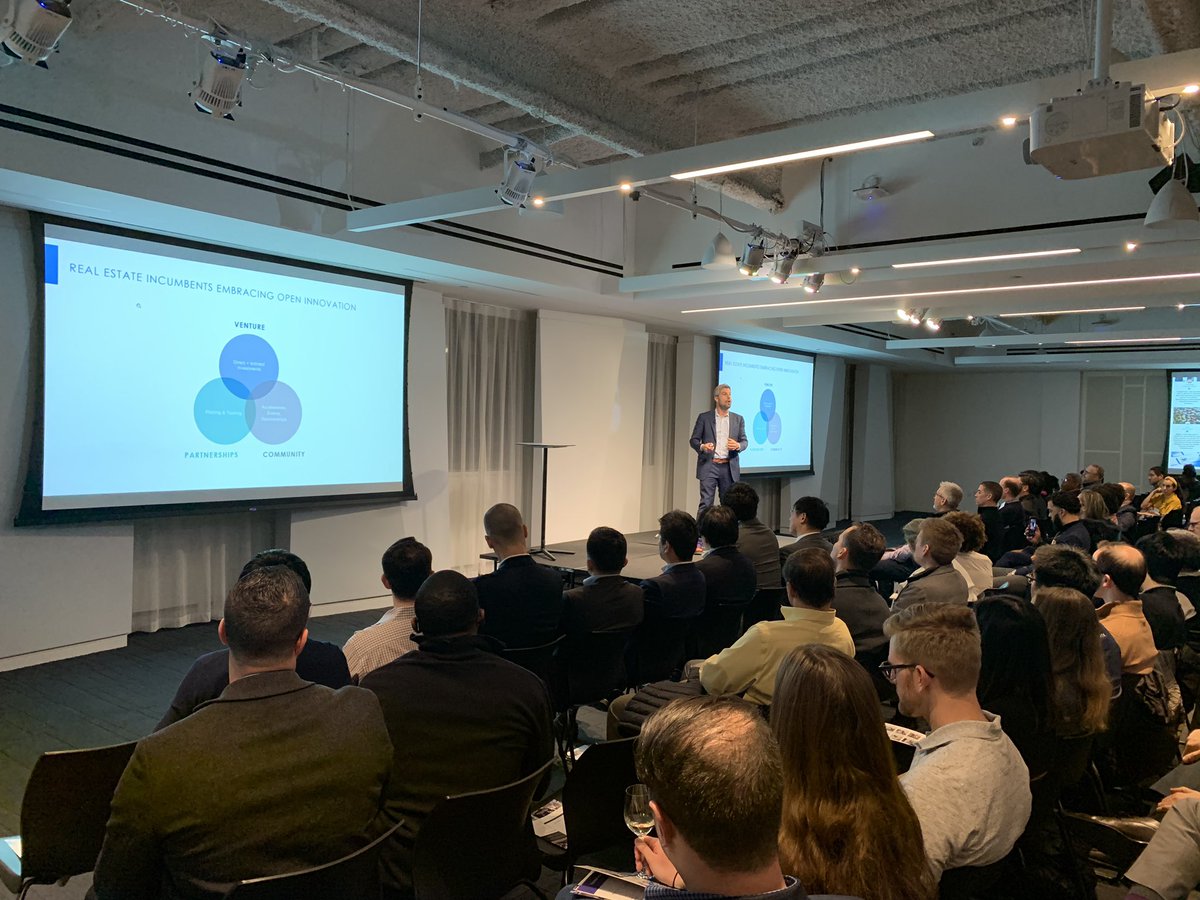 RJSBaxter's tweet photo. The High Priest of #PropTech @ZacharyAarons dives into his annual State of Union. So much momentum!

His 2020 predictions:
- 1st close w/o wet signatures
- @Airbnb IPO or #DiePO
- 1st carbon neutral bldg
- 1st #3D printed structure on Mars...in 2174

#MPDemoDay #NYC #PropTech #VC https://t.co/vpRpYEsV0n