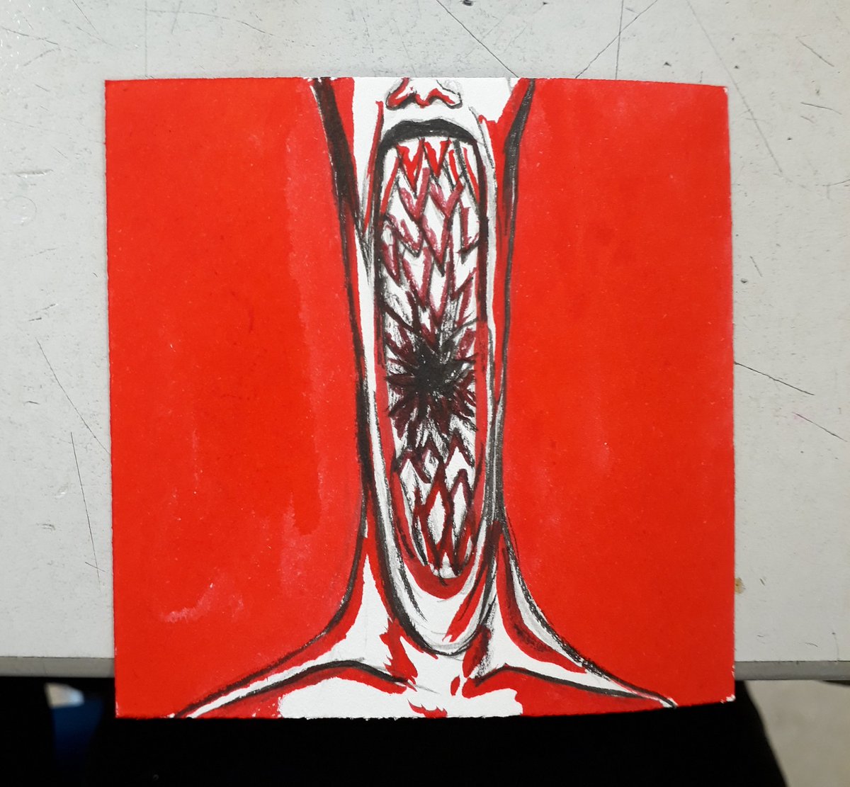 A red, black, and white ink drawing of a person's head and shoulders, starting just above the nose, showing a huge, gaping maw filled with many teeth, like a lamprey's