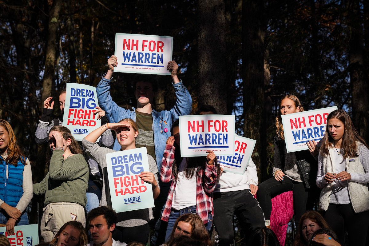 Team Warren supporters in New Hampshire stand with New Hampshire for Warren signs. 