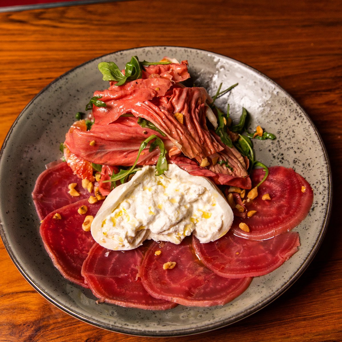 Burrata with candy cane beets, citrus, arugula and hazelnuts.🍴