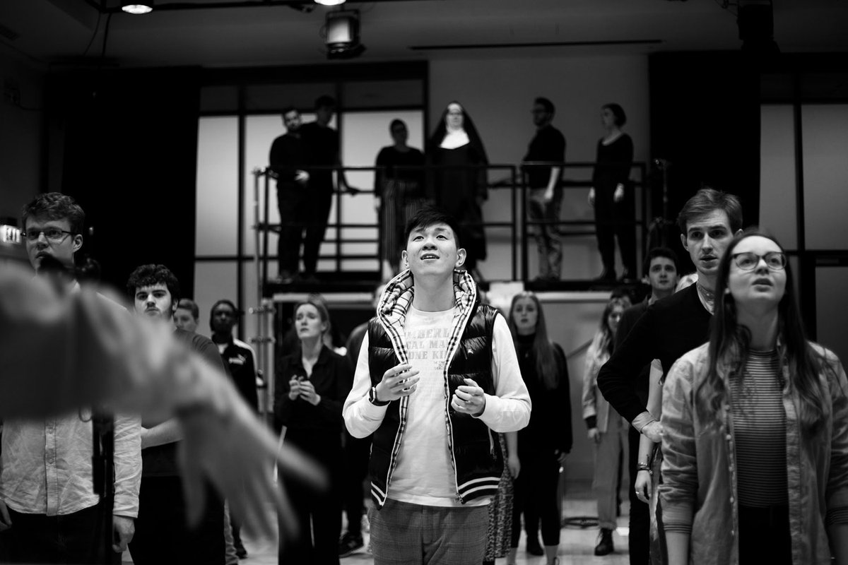 Chorus looking out and singing 