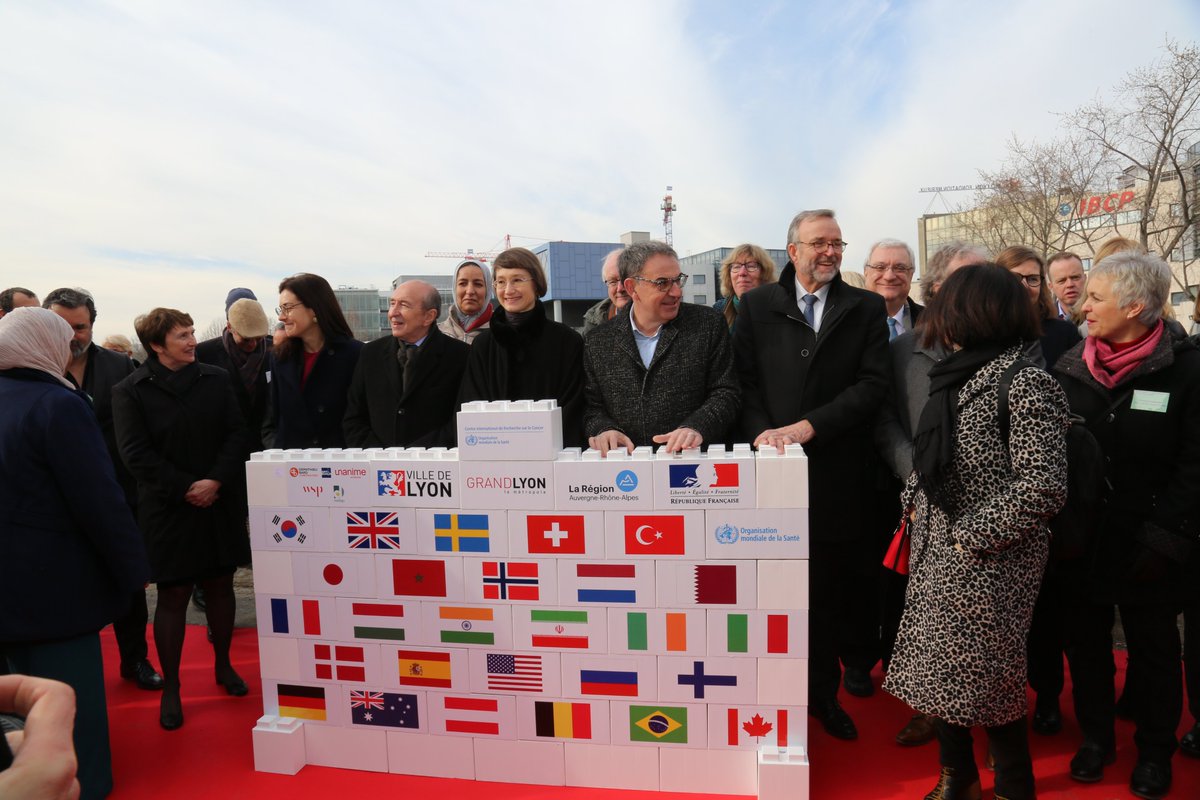 IARCWHO's tweet photo. IARC, joined by the members of the Scientific Council, representatives of @VilledeLyon, @GrandLyon, @auvergnerhalpes, & the Government of France, held a First Stone Ceremony to mark the start of construction of the future IARC headquarters in Lyon, France https://t.co/2cTZbhuKNr https://t.co/7idfNdip6H